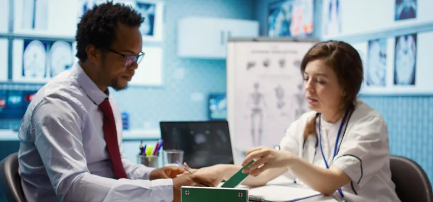 close up jar on table filled with coins against blue background
